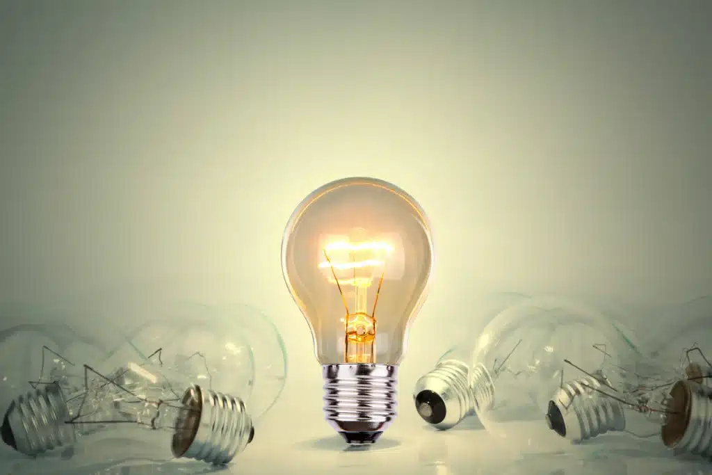 light bulb lit between many lights 1